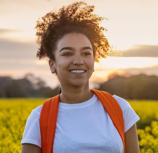 Person with backpack with sunset in the background.
