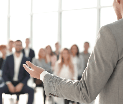 Speaker in front of people at an event.