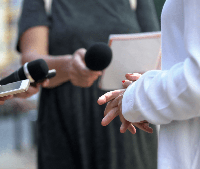 Healthcare professional speaking to media outlets.