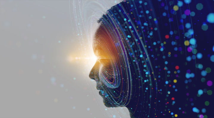 A digital silhouette of a woman's profile, illuminated with colorful light trails and specks.