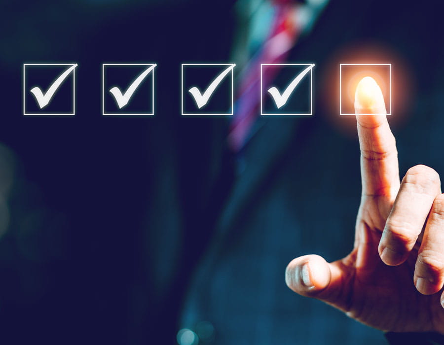 A business professional's finger poised to select the final checkbox in a series of four checkmarked boxes.