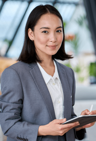 A woman in a business suit holding a tablet device.