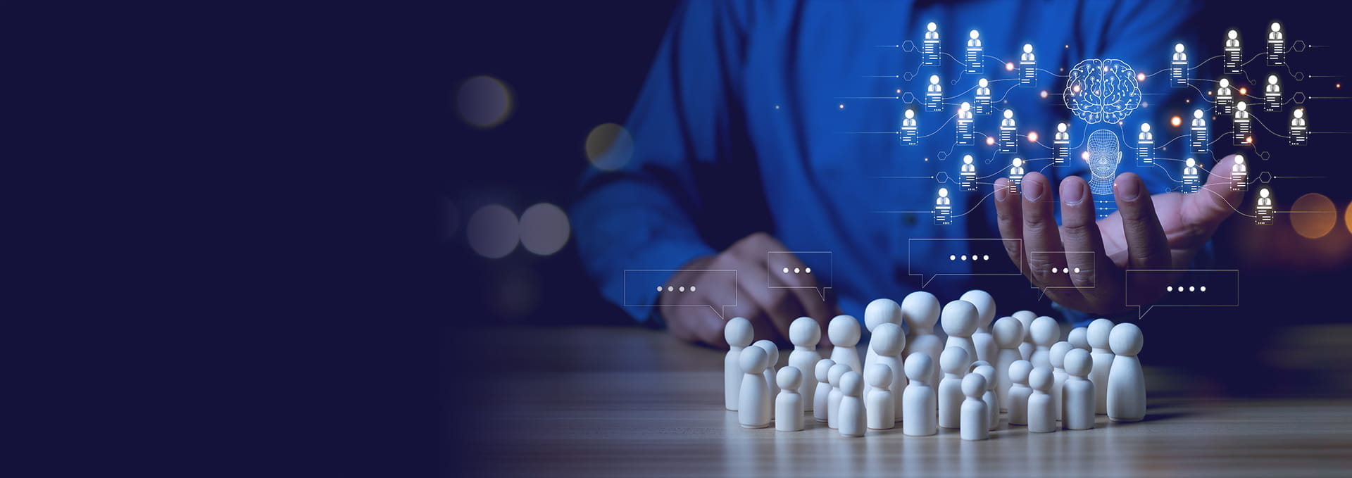 A person in a blue shirt gestures towards digital connections above a group of small white figurines.