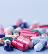 A group of generic pills on a blue surface.