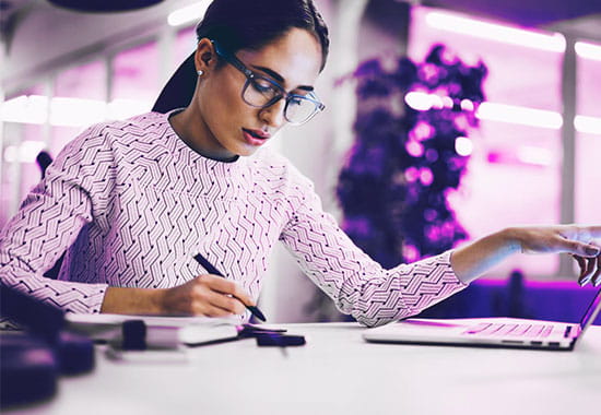 Disclosure expert working at her desk reviewing documents.