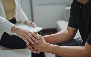 Comforting patient with clapsed hands