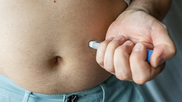 Person performing self-injections.