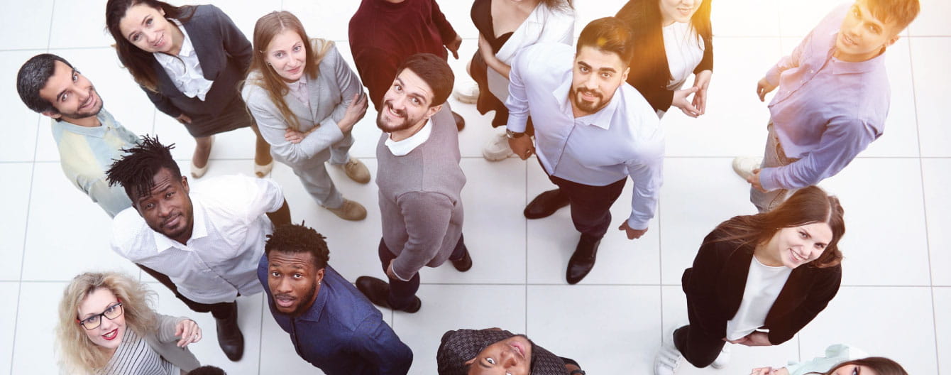 A diverse group of people looking up.