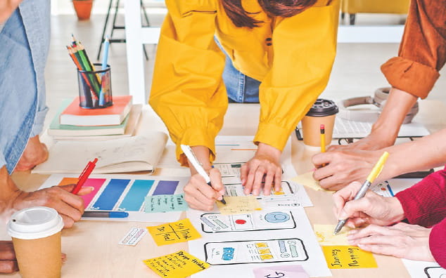 Group of people collaborating around a table.