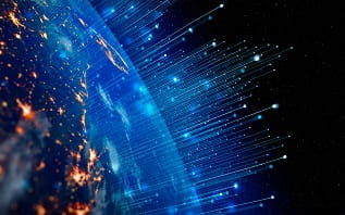 Image showing our planet in space illuminated in bright orange lights and emitting blue laser like rays