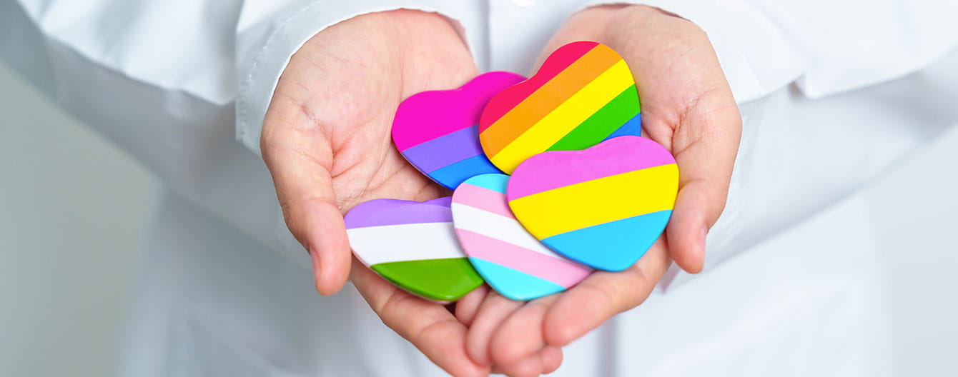 Doctor holding heart with flags of LGBTQIA.