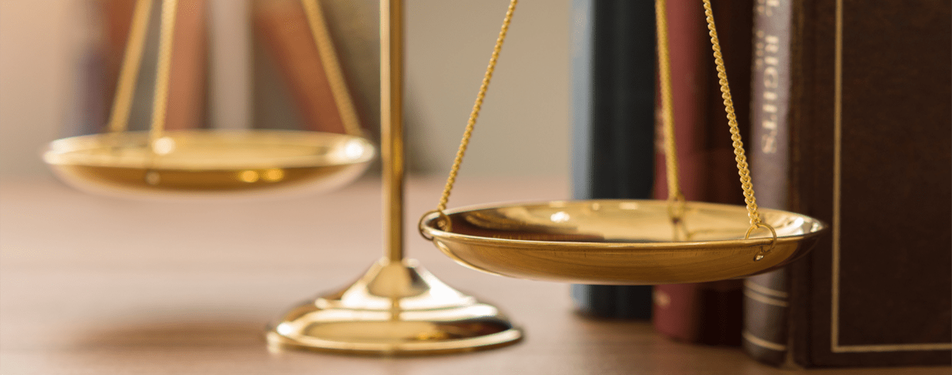 Scales of justice and legal book in courtroom