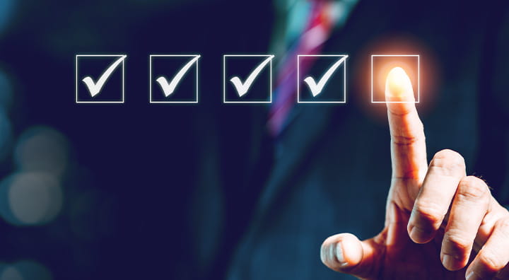 A finger hovers over an illuminated checkbox among several checked boxes, symbolizing task completion.