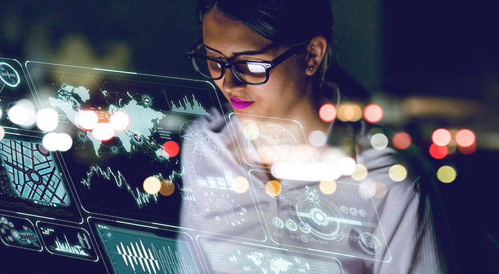 A person analyzes data displayed on a high-tech interface.