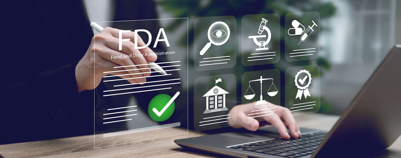 Person using a laptop and stylus with FDA approval and medical research icons floating on screen.