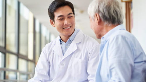 Healthcare professional and patient sitting together.